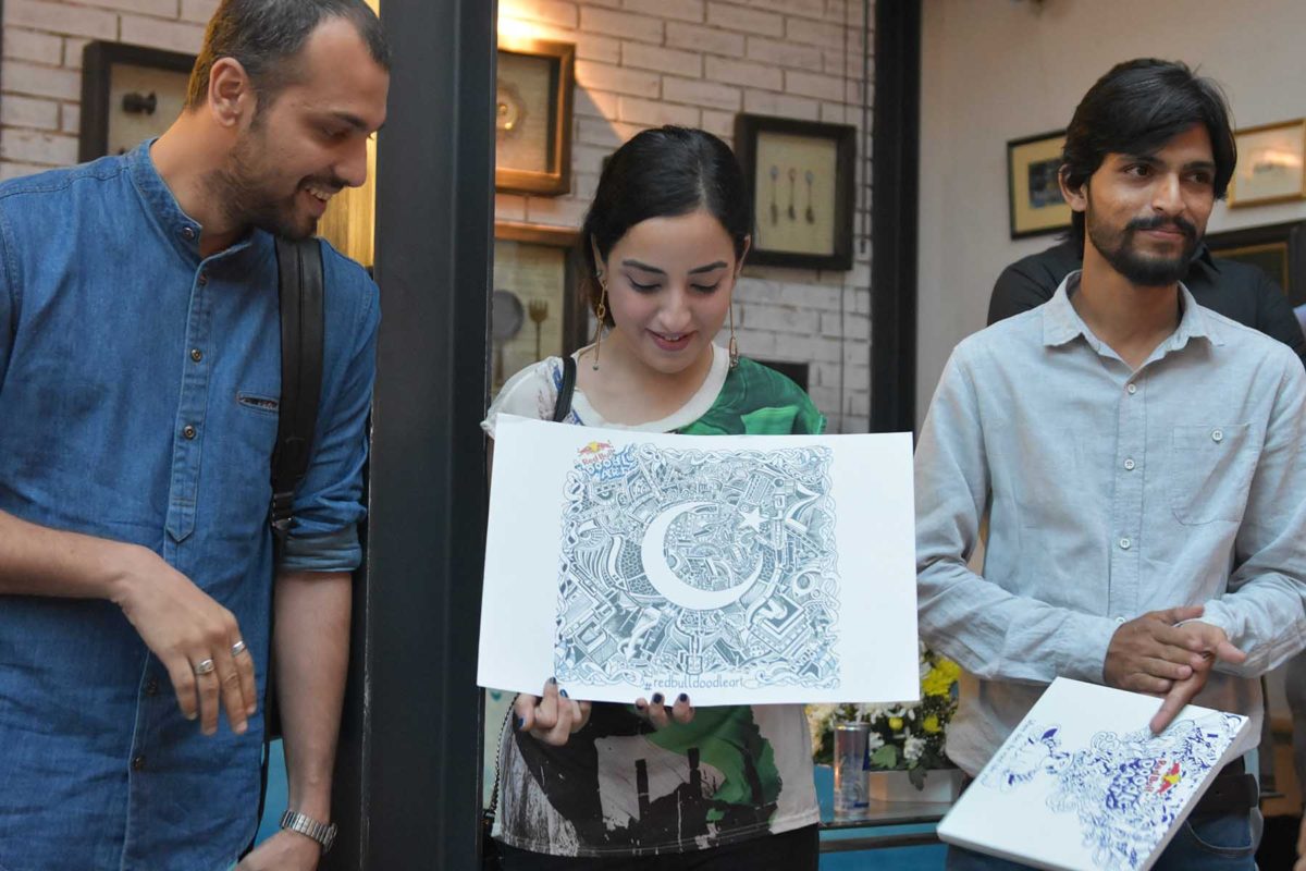 Saad, Samya and SM Raza presenting Umer Nadeem’s winning doodle